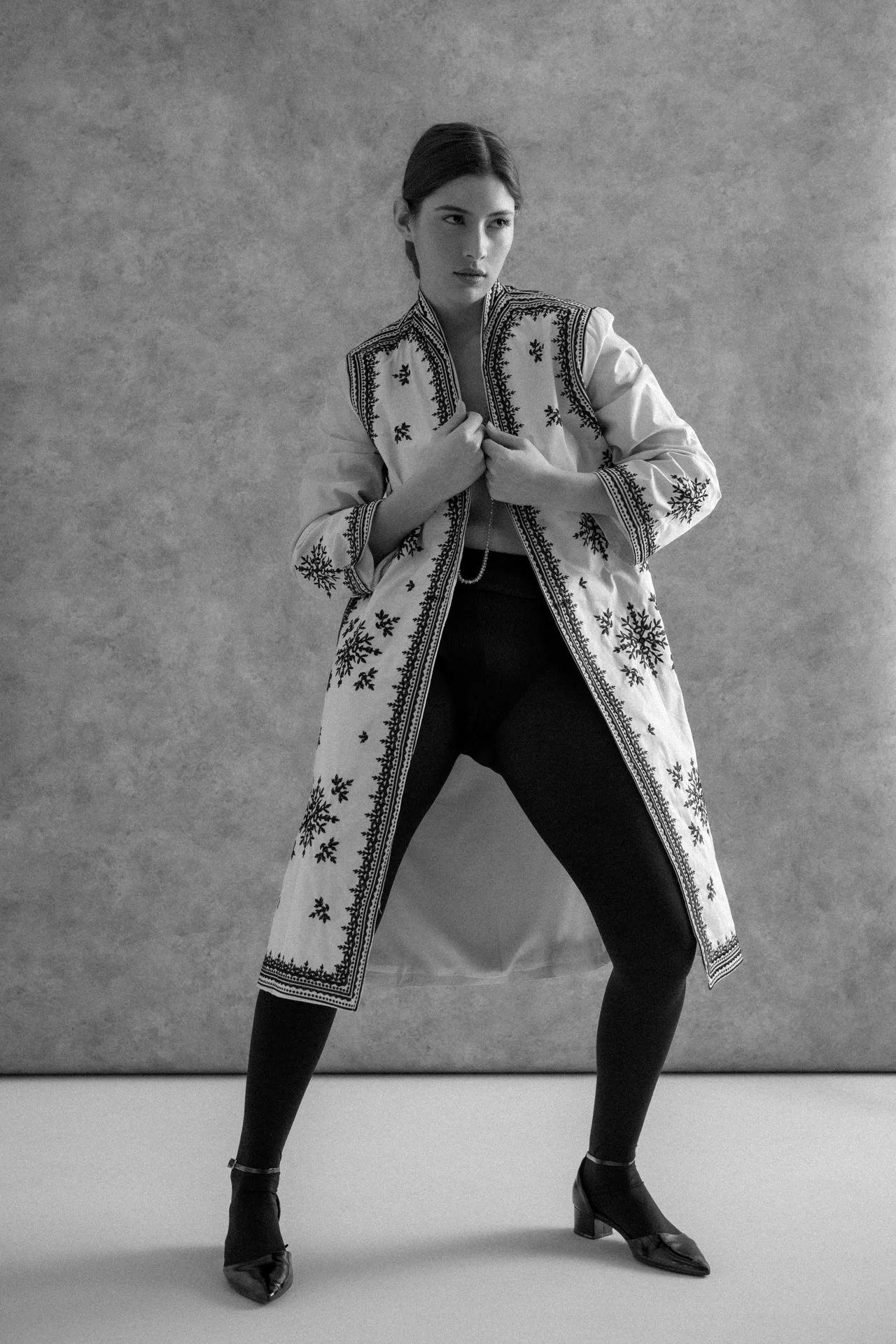 Editorial de moda en blanco y negro con abrigo estampado